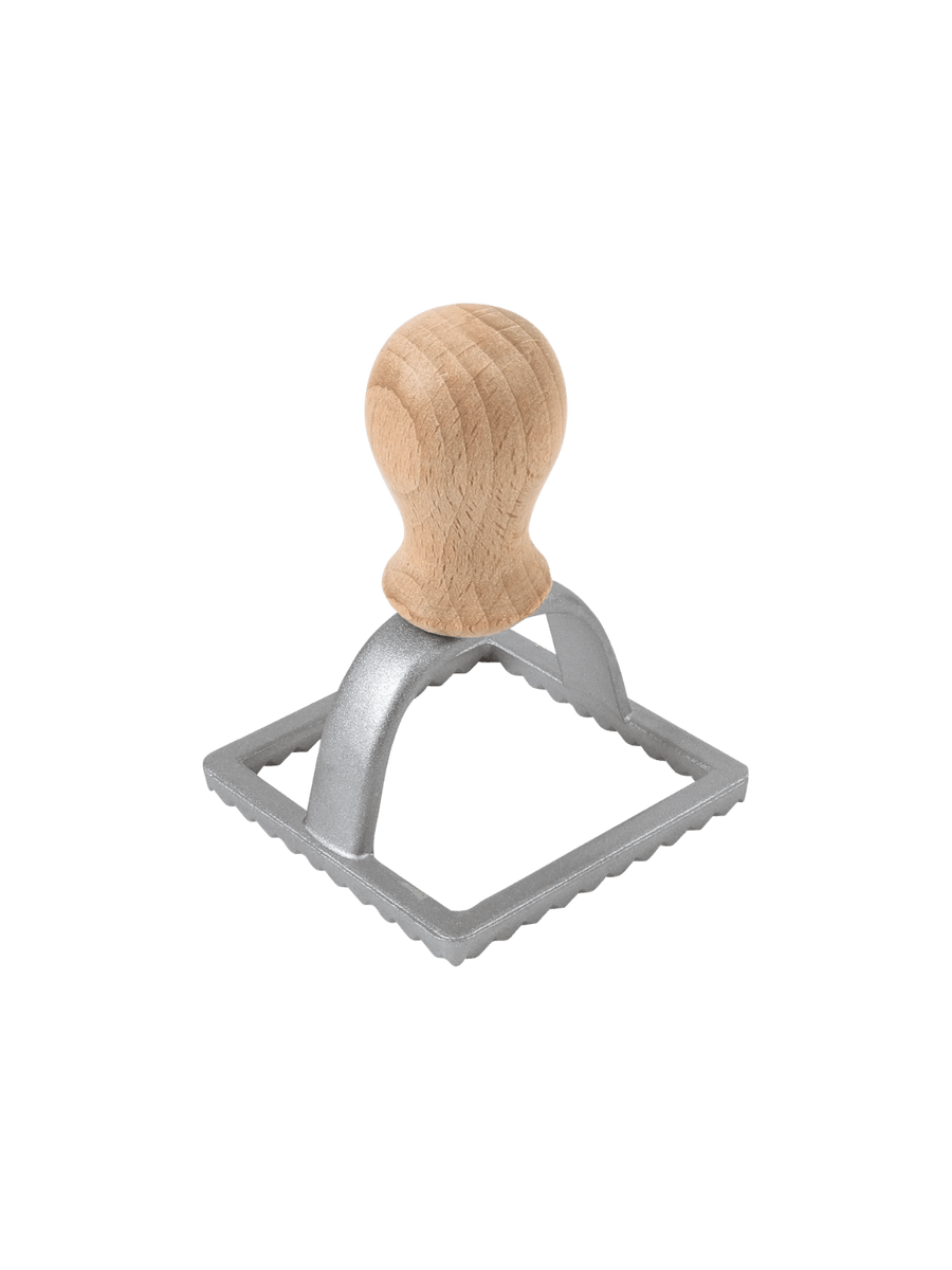 Metal ravioli stamp with wooden handle from Burstenhaus Redecker on a transparent background | Twentyseven Toronto
