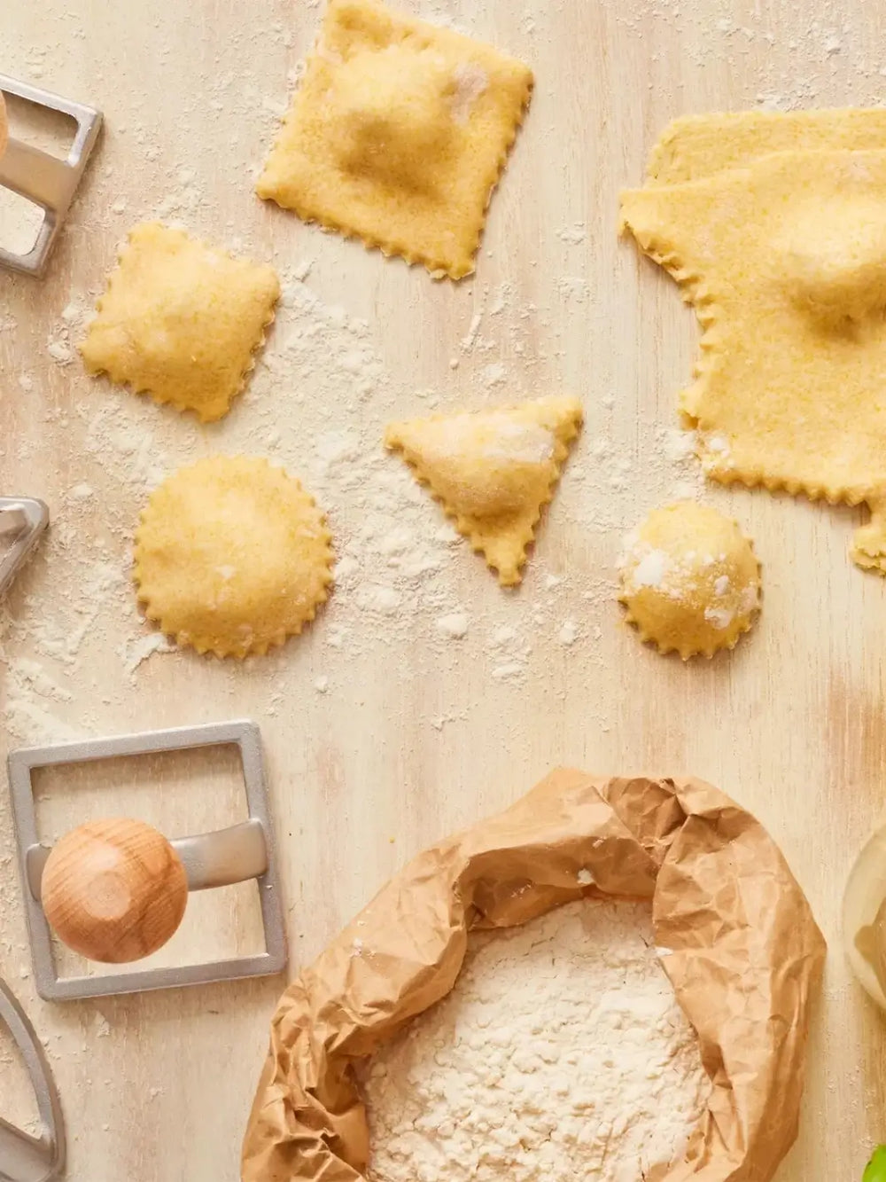 Uncooked ravioli on a floured surface with a Burstenhaus Redecker ravioli stamps | Twentyseven Toronto