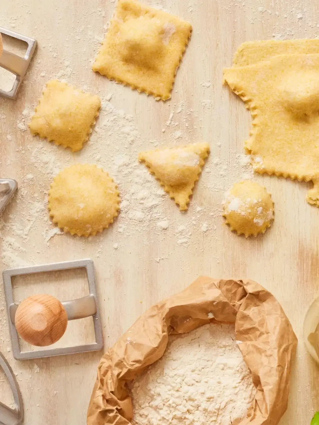 Uncooked ravioli on a floured surface with a Burstenhaus Redecker ravioli stamps | Twentyseven Toronto
