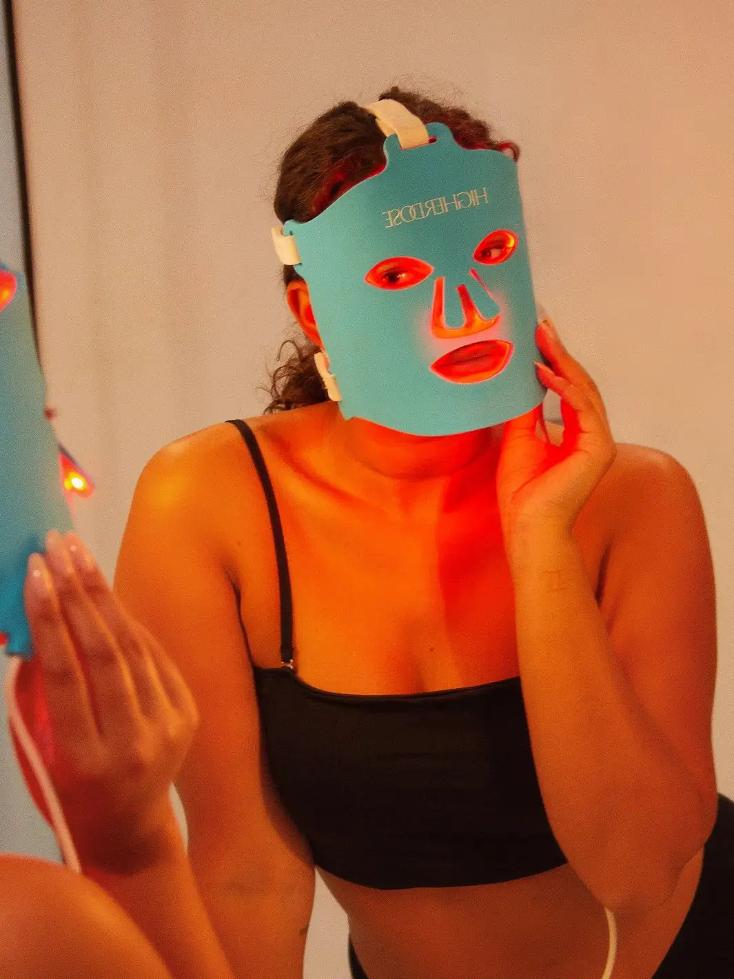 Person wearing a blue red light face mask from Higher Dose in a bathroom | Twentyseven Toronto