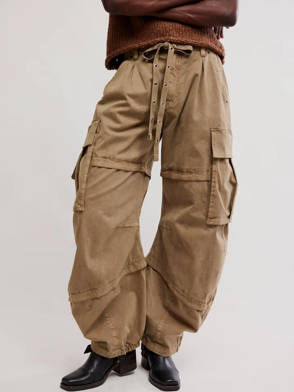 Cropped lower-body shot of a model wearing Free People We the Free Reef Curved Twill Cargo Pants in Aloe paired with black boots | Twentyseven