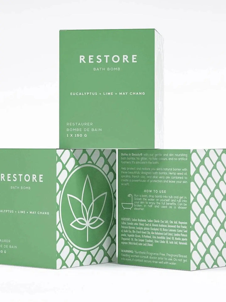 Three green boxes for the Bare Skin Bar RESTORE Bath Bomb are stacked to display the front, side hemp leaf graphic, and back usage directions | Twentyseven Toronto