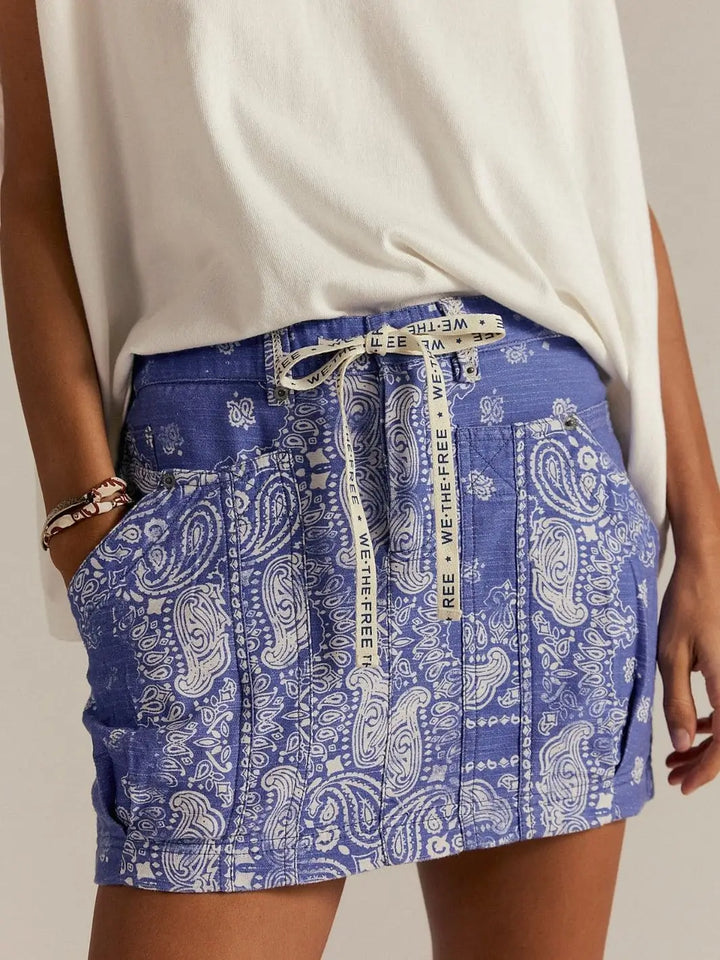 A close-up front view highlights the blue bandana-inspired print, utility pockets, and logo-printed drawstring waist of the Free People River Canyon Printed Mini Skirt - Midnight Combo | Twentyseven Toronto