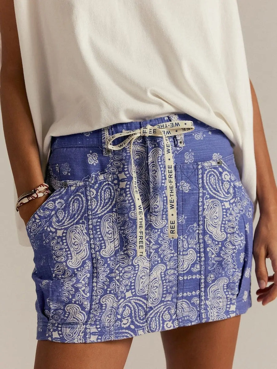 A close-up front view highlights the blue bandana-inspired print, utility pockets, and logo-printed drawstring waist of the Free People River Canyon Printed Mini Skirt - Midnight Combo | Twentyseven Toronto