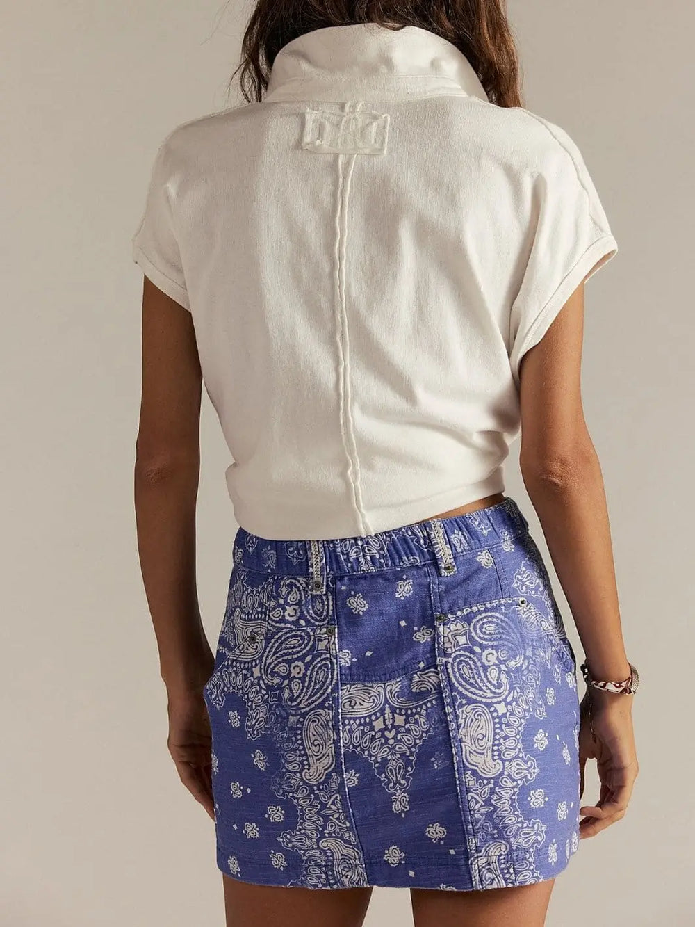 A view from the back highlights the structured paneled stitching and elasticized rear waistband of the Free People River Canyon Printed Mini Skirt - Midnight Combo | Twentyseven Toronto
