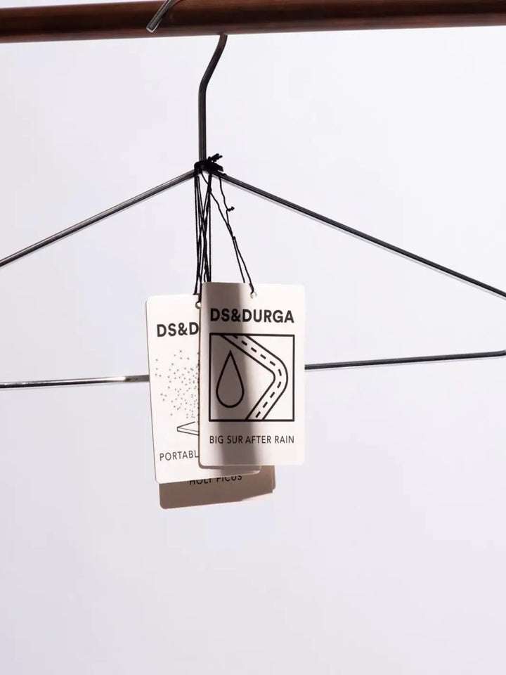 Two hanging car fragrances with 'DS&Durga' branding on a white background | Twentyseven Toronto