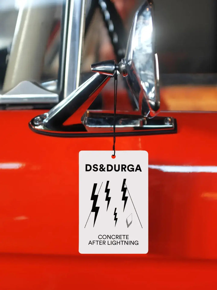 Car air freshener with DS&Durga in 'Concrete After Lightning' on a red car | Twentyseven Toronto