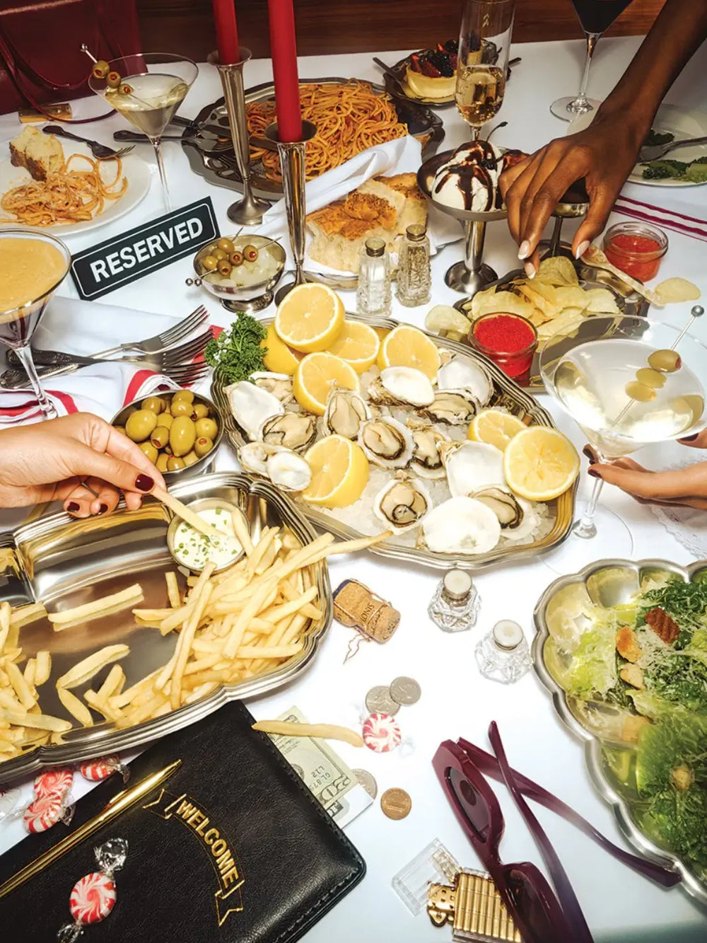 A vibrant dinner table spread filled with oysters, french fries, salad, and cocktails serves as the artwork for the Piecework Puzzles Romaine Holiday 1000 Piece Puzzle | Twentyseven Toronto