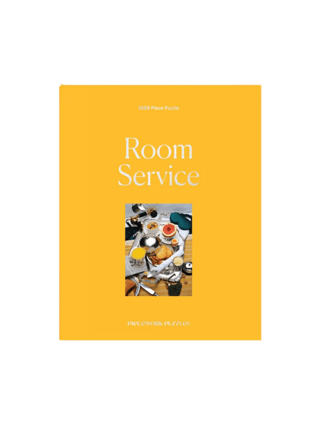The Piecework Puzzles Room Service 1000 Piece Puzzle showcases its bright yellow box cover | Twentyseven Toronto