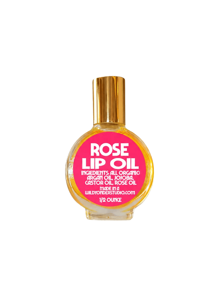 Wild Yonder Studio Rose Lip Oil in a glass bottle with a bright pink label and gold cap | Twentyseven Toronto