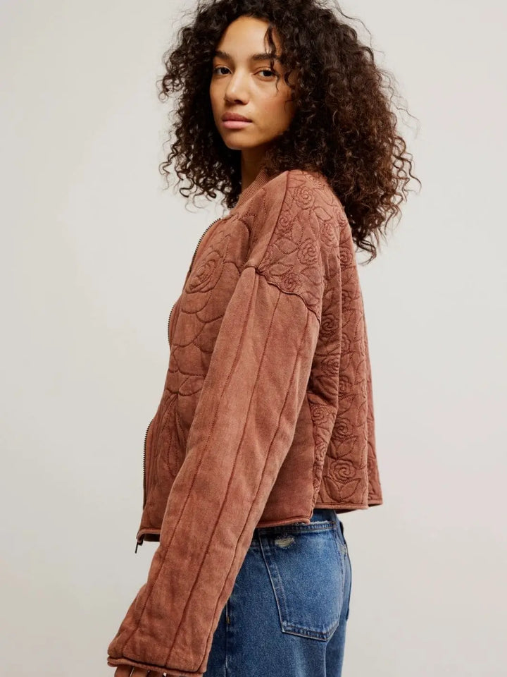 A side profile view highlights the dropped shoulders, vertical sleeve stitching, and cropped hemline of the Free People Rose Zip-Up Sweatshirt - Cinnamon Stick | Twentyseven Toronto
