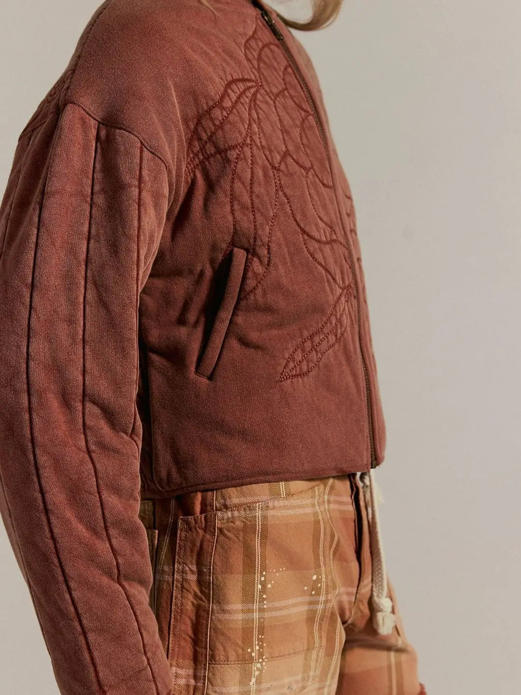 A side angle showcases the structured waist hem and the clean welt opening of the side pocket on the Free People Rose Zip-Up Sweatshirt - Cinnamon Stick | Twentyseven Toronto