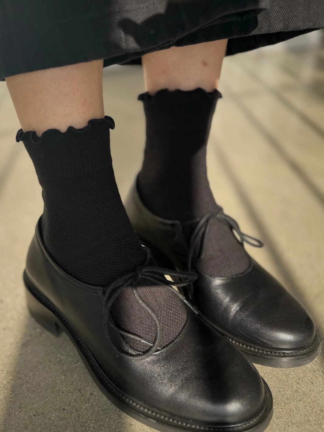 Le Bon Shoppe Ruffler Hugger Crew Socks in Black/Black styled with black leather shoes | Twentyseven Toronto