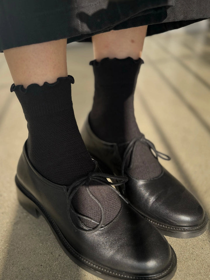 Le Bon Shoppe Ruffler Hugger Crew Socks in Black/Black styled with black leather shoes | Twentyseven Toronto