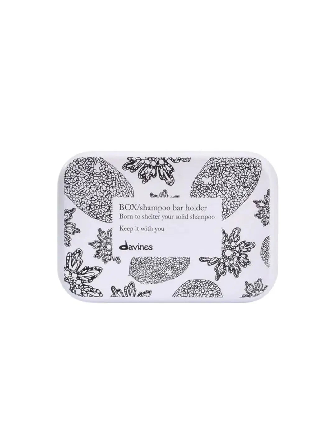 A rectangular white Davines Shampoo Bar Travel Case features a black floral and botanical pattern with a central label text against a white background | Twentyseven Toronto