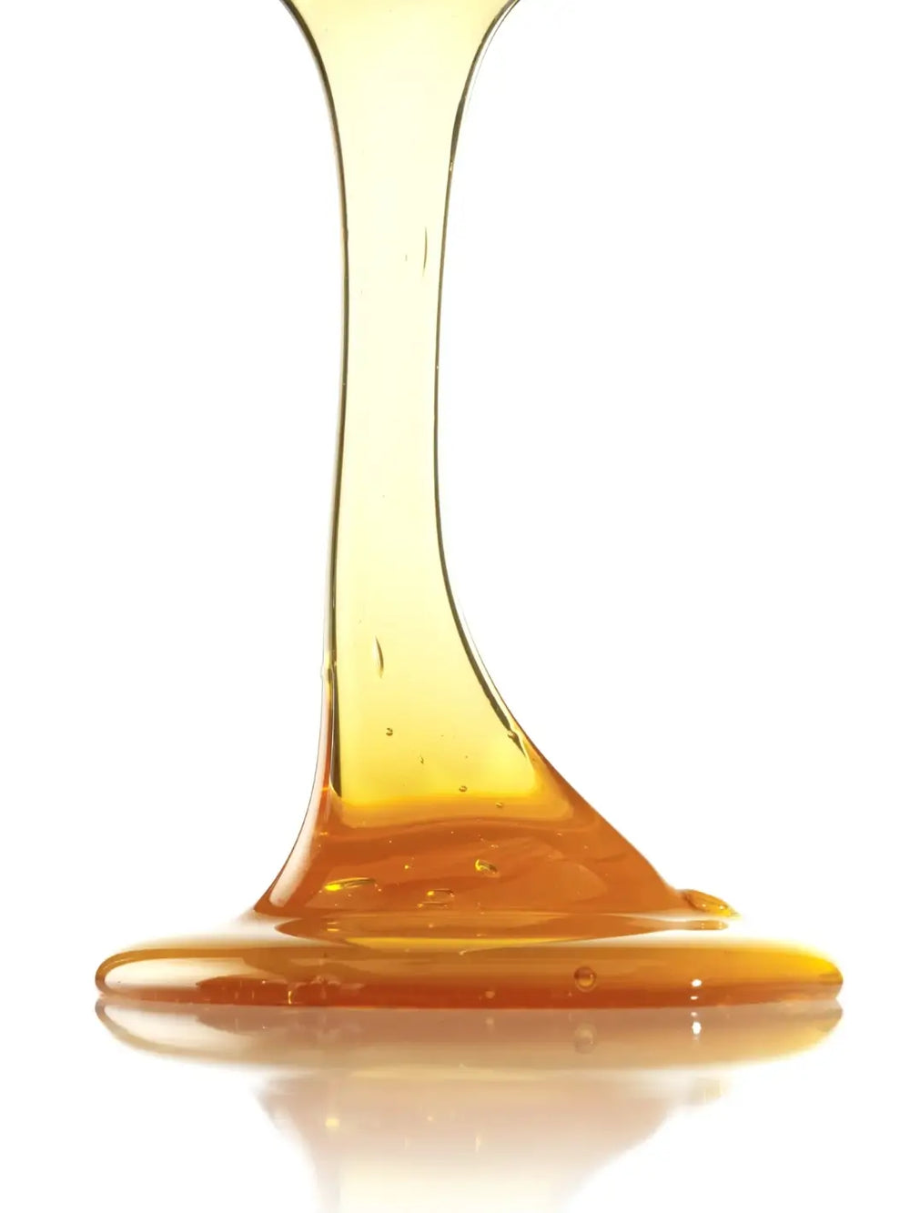 Amber liquid of Leonor Greyl 'Shampooing au Miel' shampoo being poured | Twentyseven Toronto