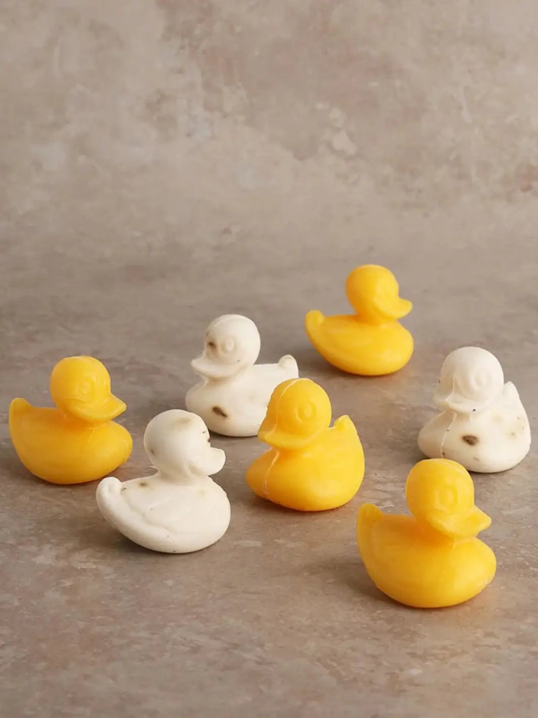 Set of yellow and white Sheep's Milk Soap in 'Duckling' from Burstenhaus Redecker on a beige background | Twentyseven Toronto