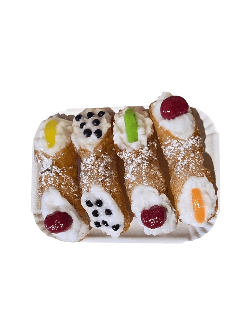 4 Sicilian Cannolo Candles with cream, berries, and colourful decorations on a white plate from Cereria Introna against a transparent background | Twentyseven Toronto