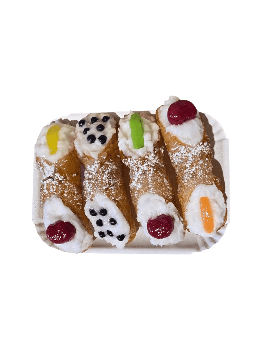4 Sicilian Cannolo Candles with cream, berries, and colourful decorations on a white plate from Cereria Introna against a transparent background | Twentyseven Toronto