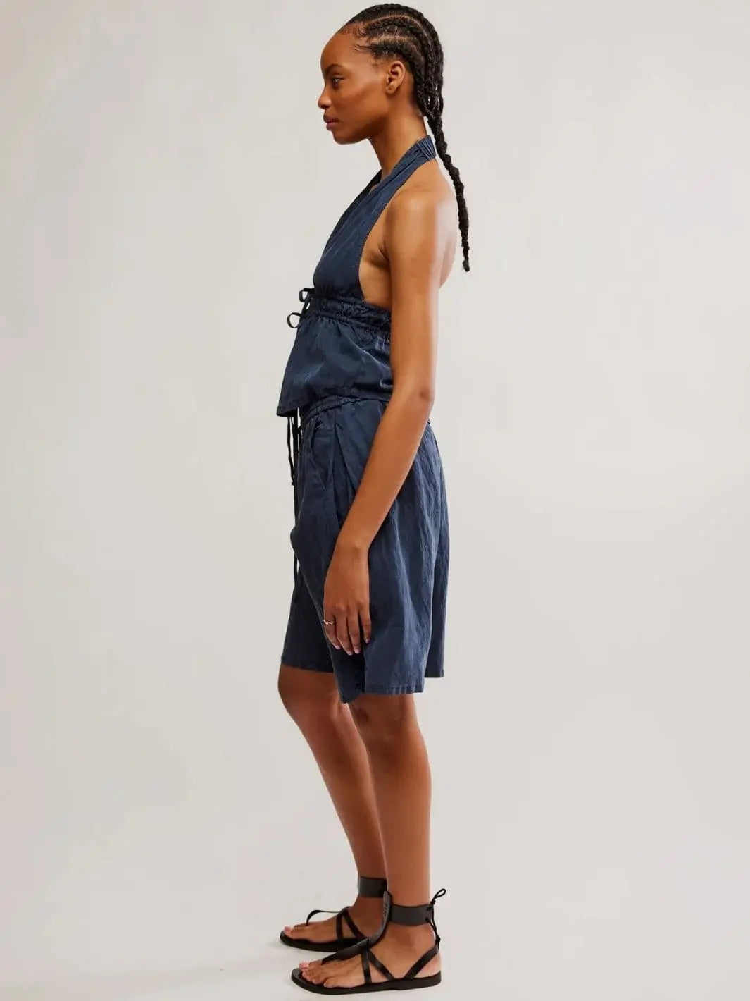 A side profile view shows the relaxed fit, mid-length hemline of the shorts, and the open-back styling of the Free People Sidra Set - India Ink | Twentyseven Toronto