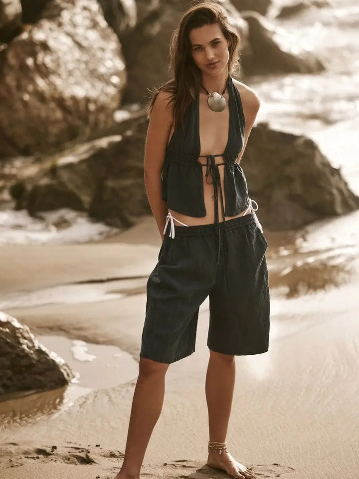 A candid beachside view captures the breezy, casual drape of the Free People Sidra Set - India Ink on a model | Twentyseven Toronto