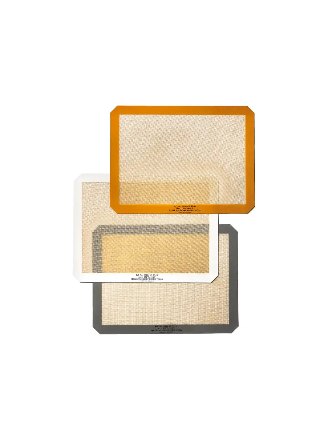 Three colours of the Silicone Placemat from Puebco are layered diagonally to showcase their different borders in vibrant orange, clean white, and dark grey | Twentyseven Toronto