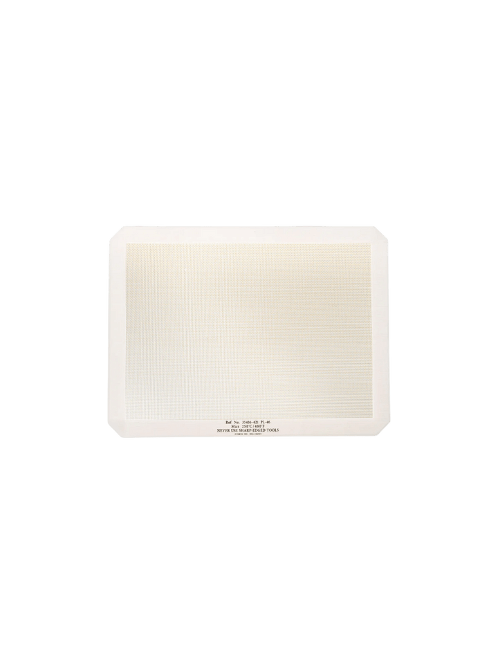 A single white-bordered rectangular Silicone Placemat from Puebco is displayed flat, highlighting its textured fiberglass mesh center | Twentyseven Toronto