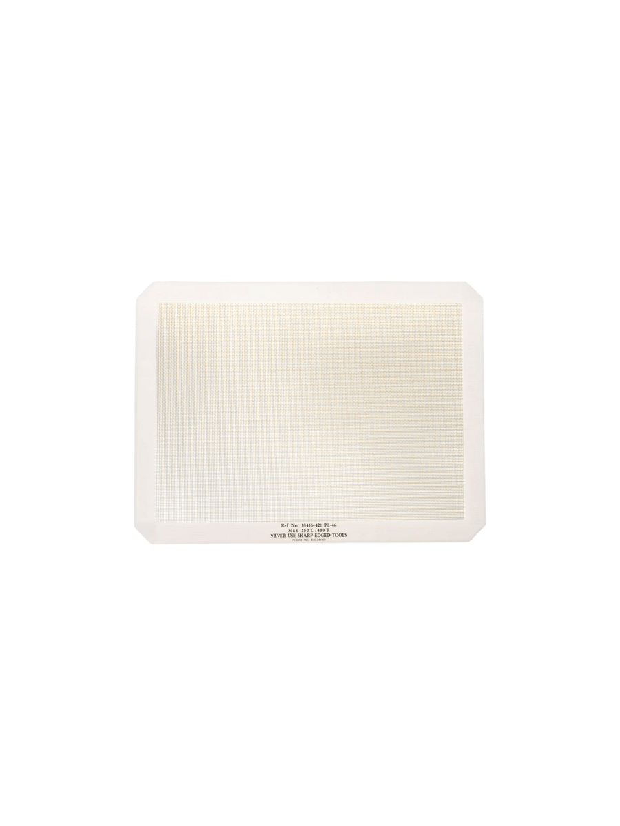 A single white-bordered rectangular Silicone Placemat from Puebco is displayed flat, highlighting its textured fiberglass mesh center | Twentyseven Toronto