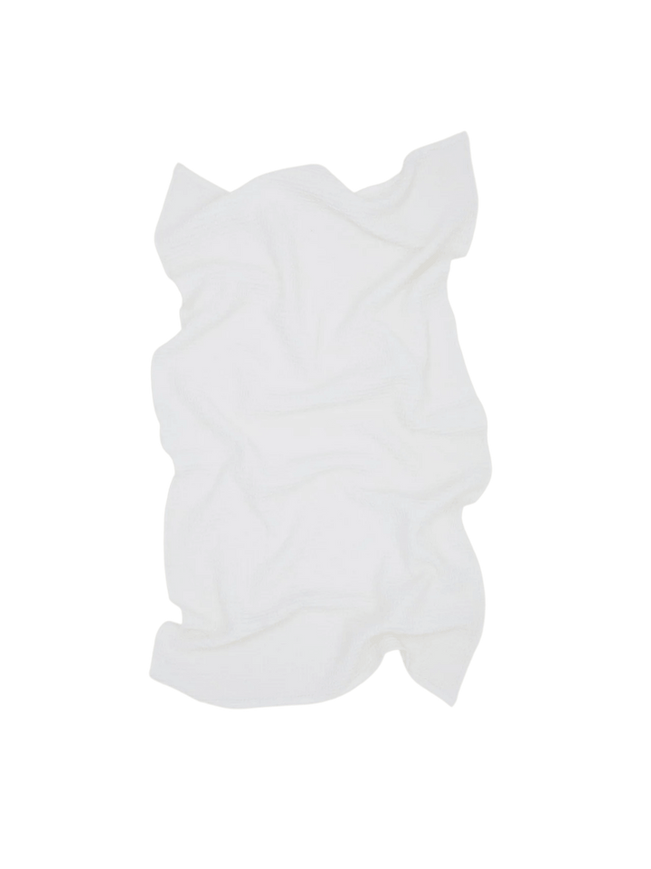 A white towel artfully crumpled showcasing the unique texture of the Simple Waffle Towel - White from Hawkins New York against a transparent background | Twentyseven Toronto