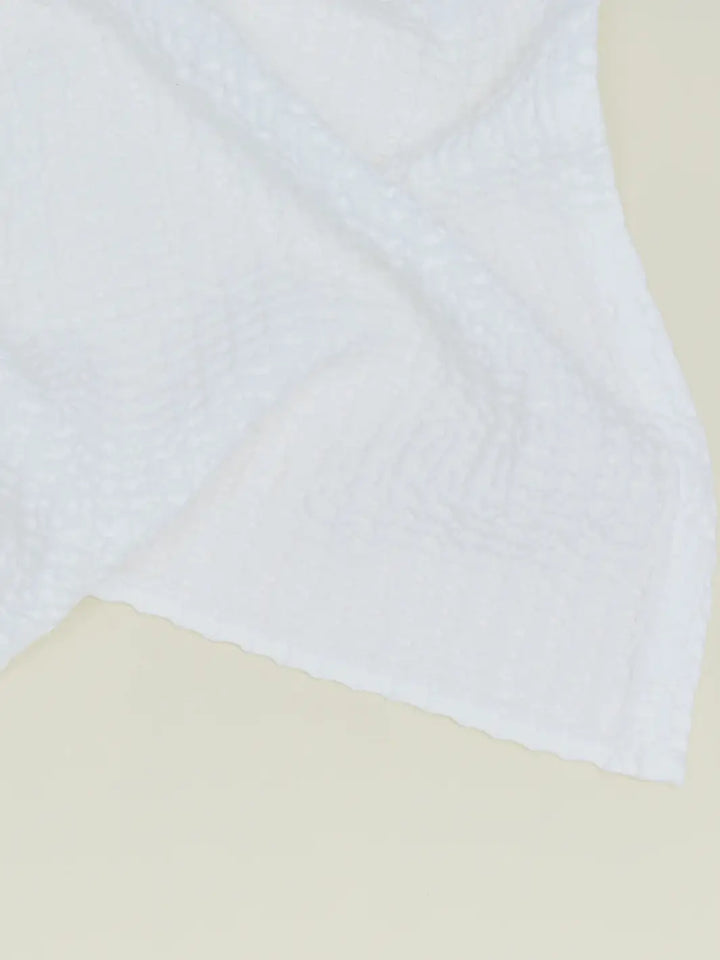 A close-up view highlights the intricate woven grid texture of a white towel from the Simple Waffle Towel - White from Hawkins New York collection | Twentyseven Toronto