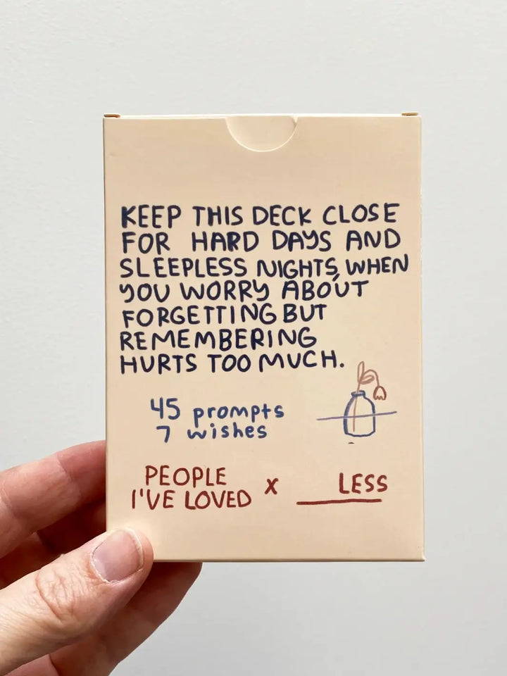 The back of the Sitting With Sadness Deck from People I've Loved highlights that the set includes 45 prompts and 7 wishes to help navigate the pain of remembering and forgetting | Twentyseven Toronto
