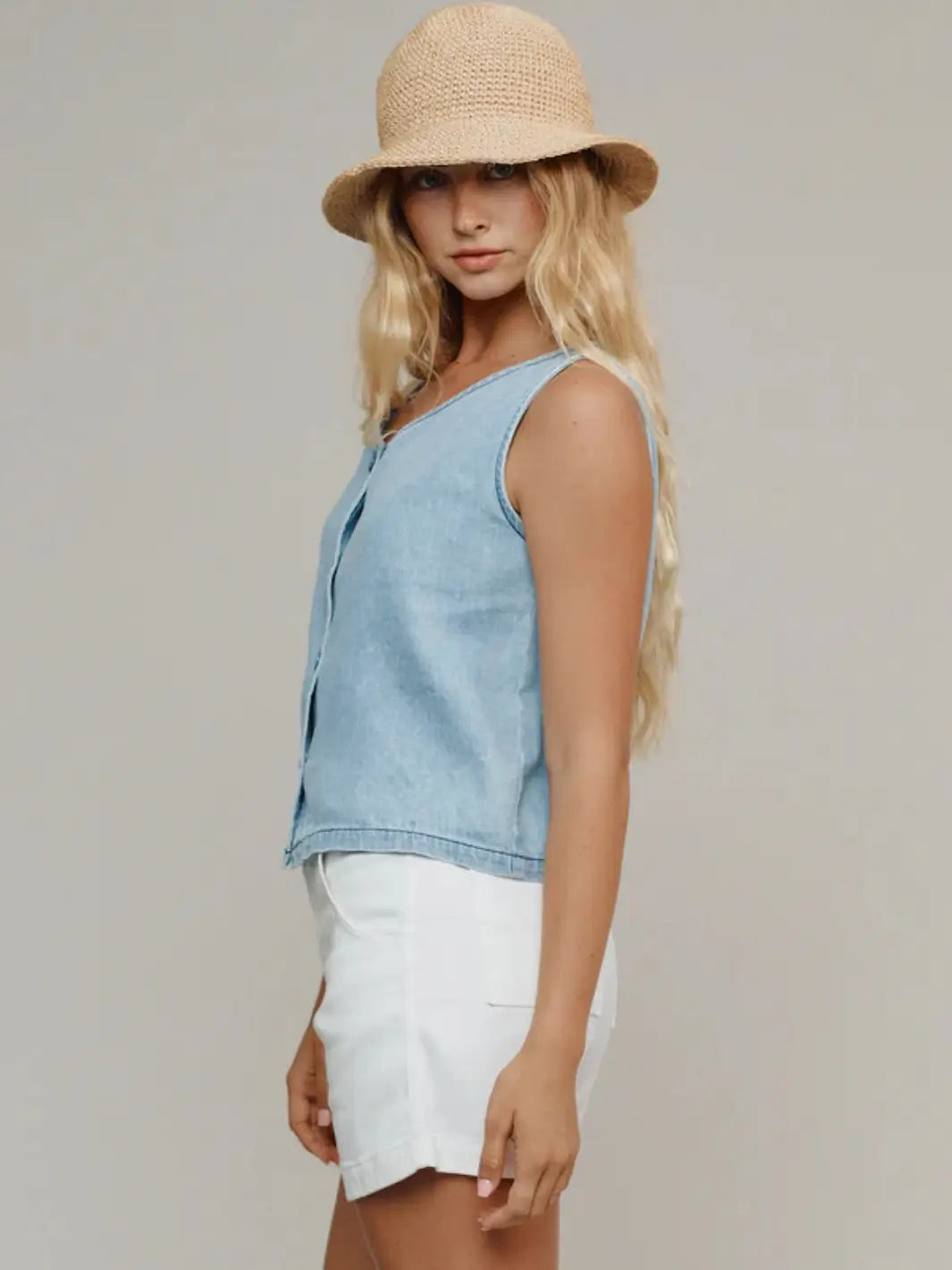 A side profile shot highlights the relaxed fit and light wash design of the Jungmaven Skyline Summer Denim Vest - Light | Twentyseven Toronto