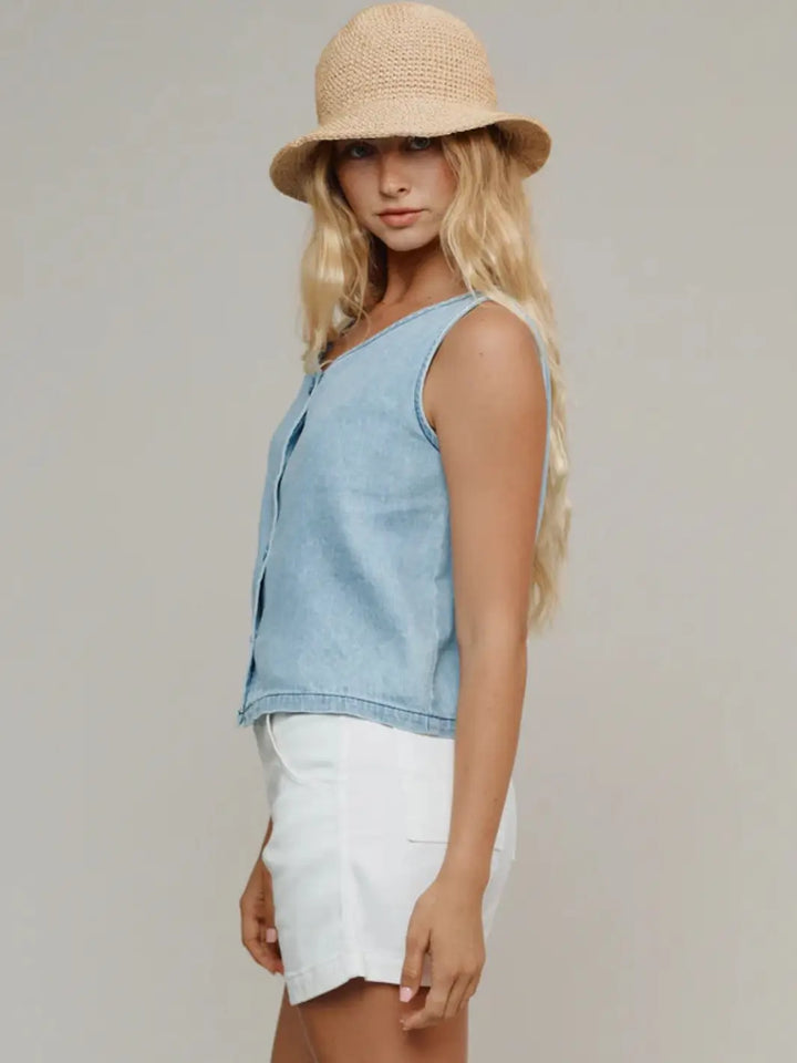 A side profile shot highlights the relaxed fit and light wash design of the Jungmaven Skyline Summer Denim Vest - Light | Twentyseven Toronto