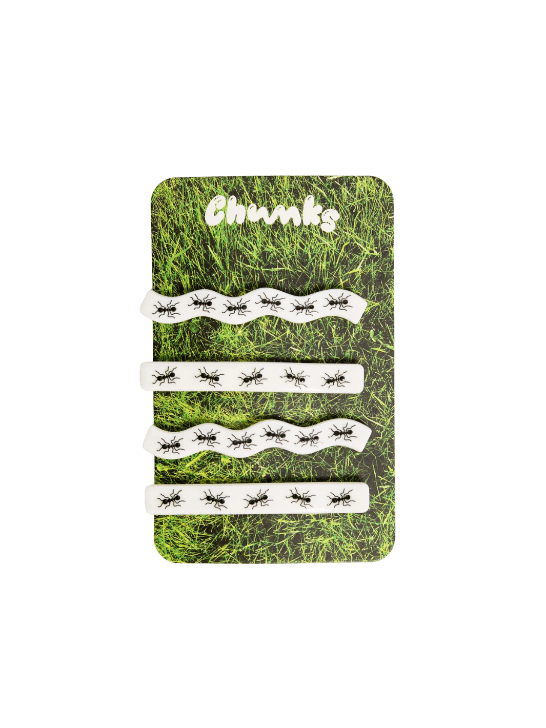 Four white hair clips decorated with a black ant print from the CHUNKS Slides in Ants Barrette set are displayed on a grass-printed backing card | Twentyseven Toronto