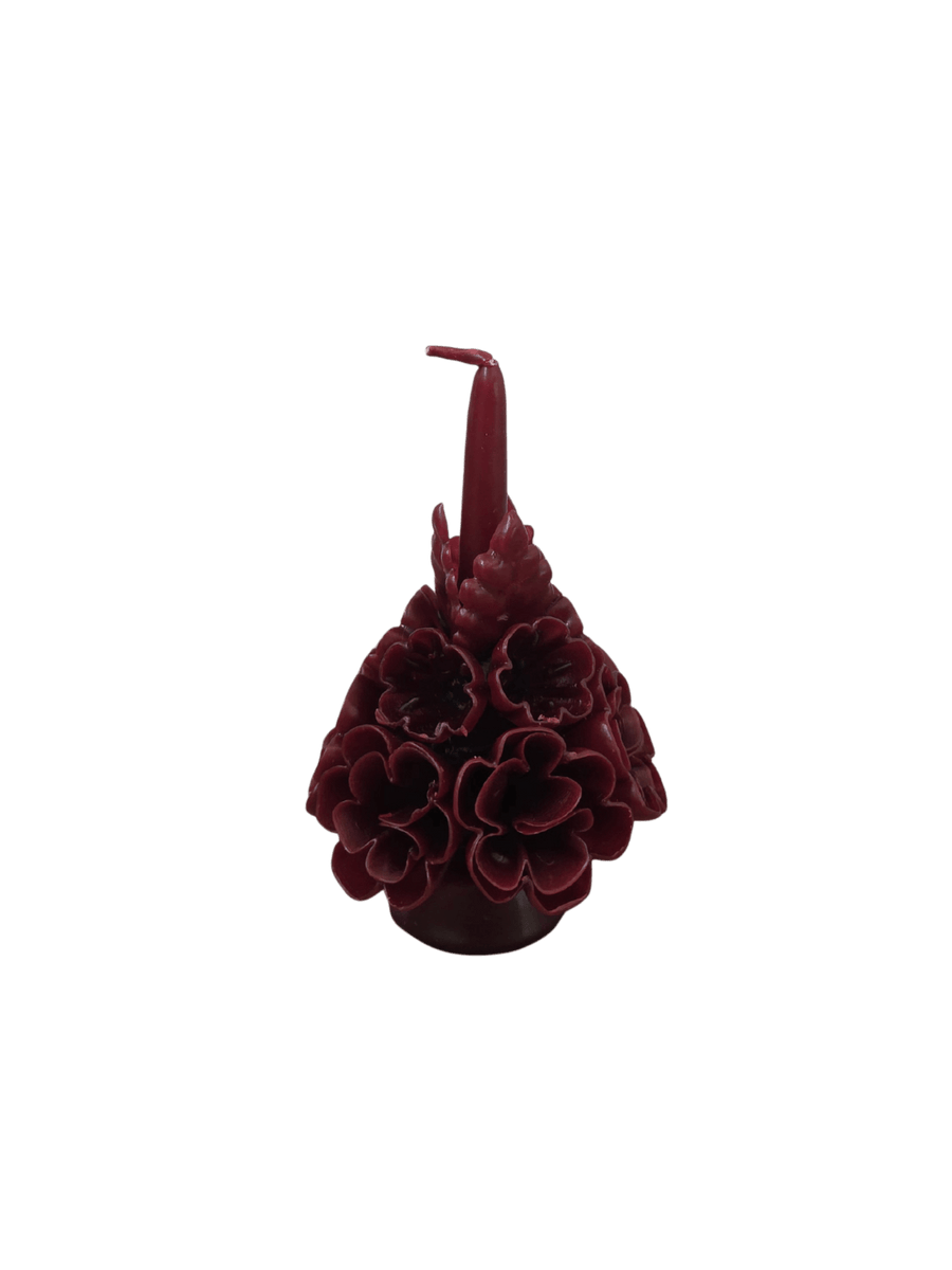 Dark red floral wax candle called the Small Flaked Candle in Burgundy from Cereria de Jesus against a transparent background | Twentyseven Toronto