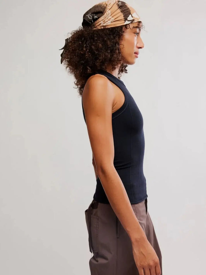 A side profile view highlights the tight fit, high neckline, and seamless texture of the Free People So Soft Seamless Modal Tank in Black | Twentyseven Toronto