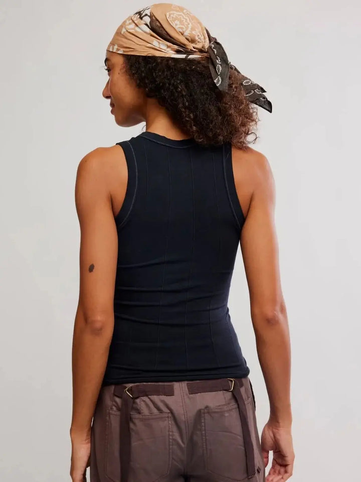 A direct rear view focuses on the racerback-style armholes and vertical ribbed paneling of the Free People So Soft Seamless Modal Tank in Black | Twentyseven Toronto
