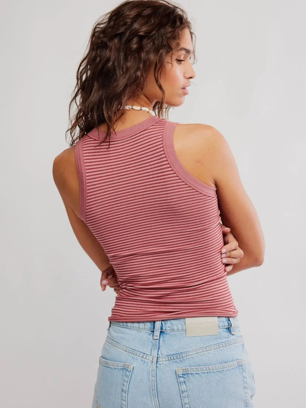 A rear view showcases the straight hemline, full back coverage, and seamless texture of the Free People So Soft Seamless Modal Tank in Rose Combo | Twentyseven Toronto