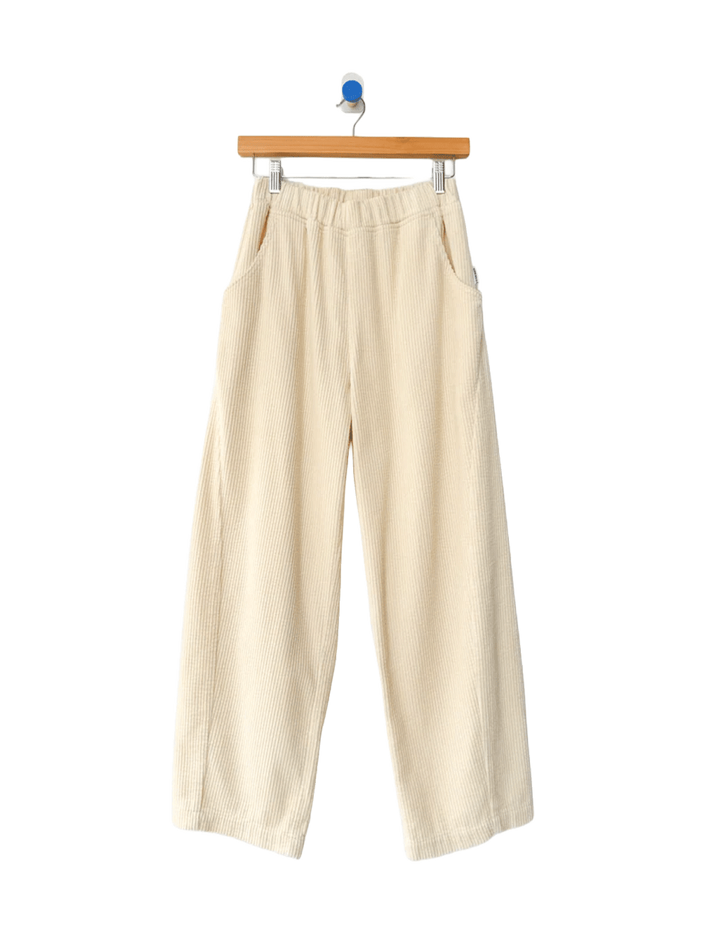Le Bon Shoppe Soft Corduroy Arc Pants in Ecru on wooden hanger, front view | Twentyseven Toronto