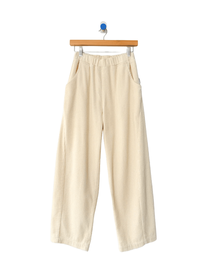 Le Bon Shoppe Soft Corduroy Arc Pants in Ecru on wooden hanger, front view | Twentyseven Toronto