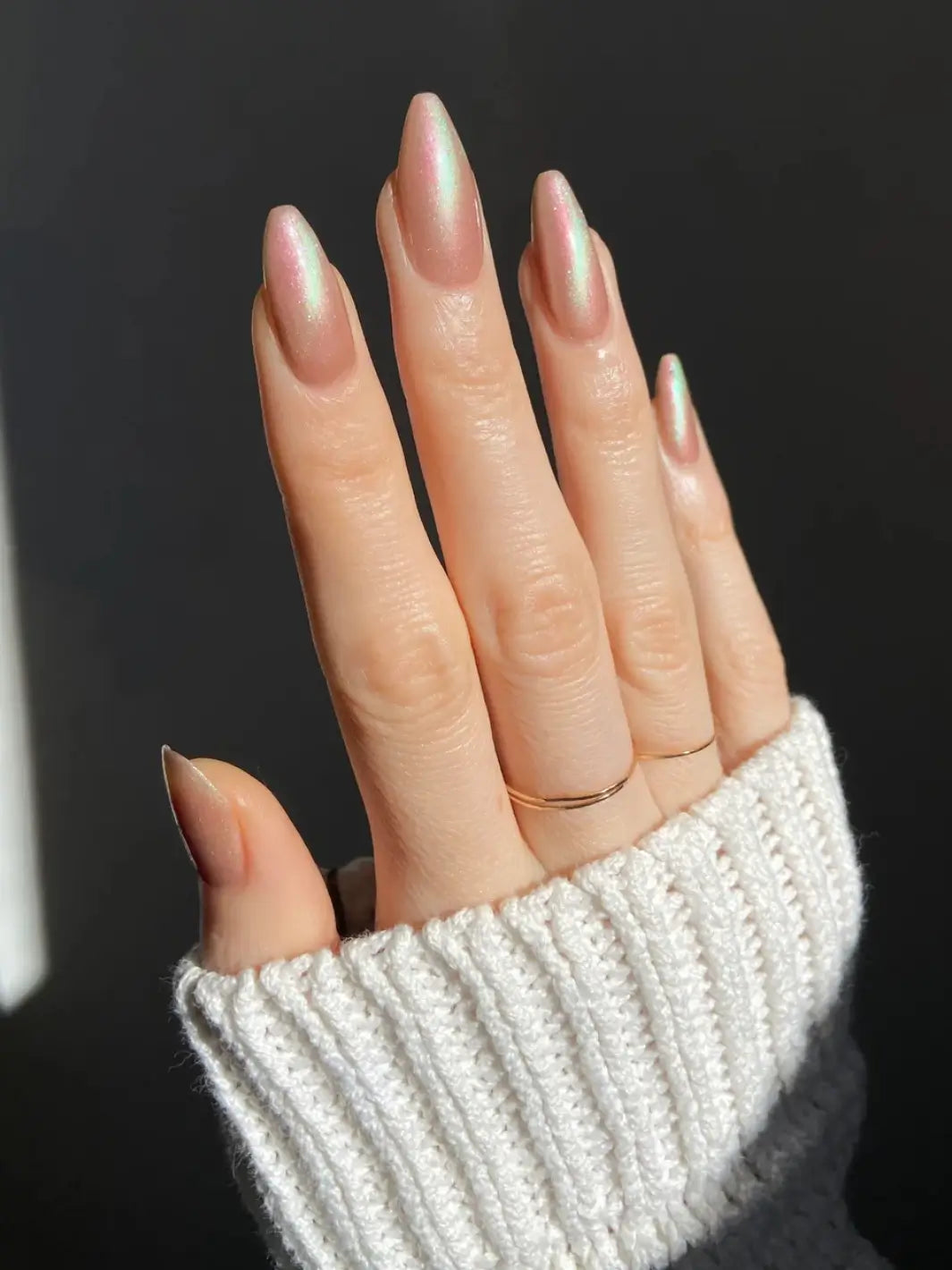 Hand with long pink and light green gradient nails using 'Something Else' magnetic nail polish by Death Valley Nail wearing a grey textured sleeve | Twentyseven Toronto