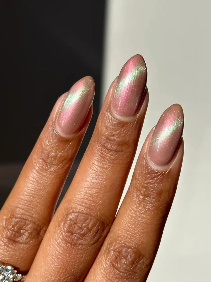 Close up of long pink and light green gradient nails using 'Something Else' magnetic nail polish by Death Valley Nails wearing a diamond ring on a neutral background | Twentyseven Toronto