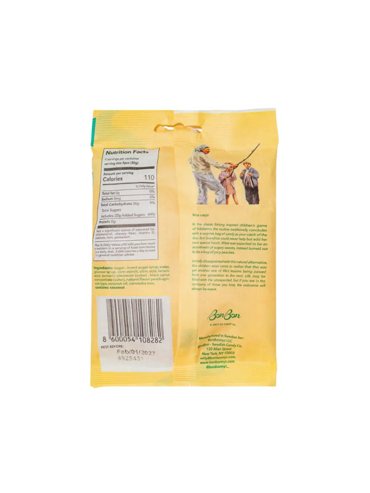 The yellow back packaging of Sour Peach Fish Swedish Candy from BonBon NYC displays nutrition facts, an ingredients list, and a small vintage illustration of people fishing | Twentyseven Toronto