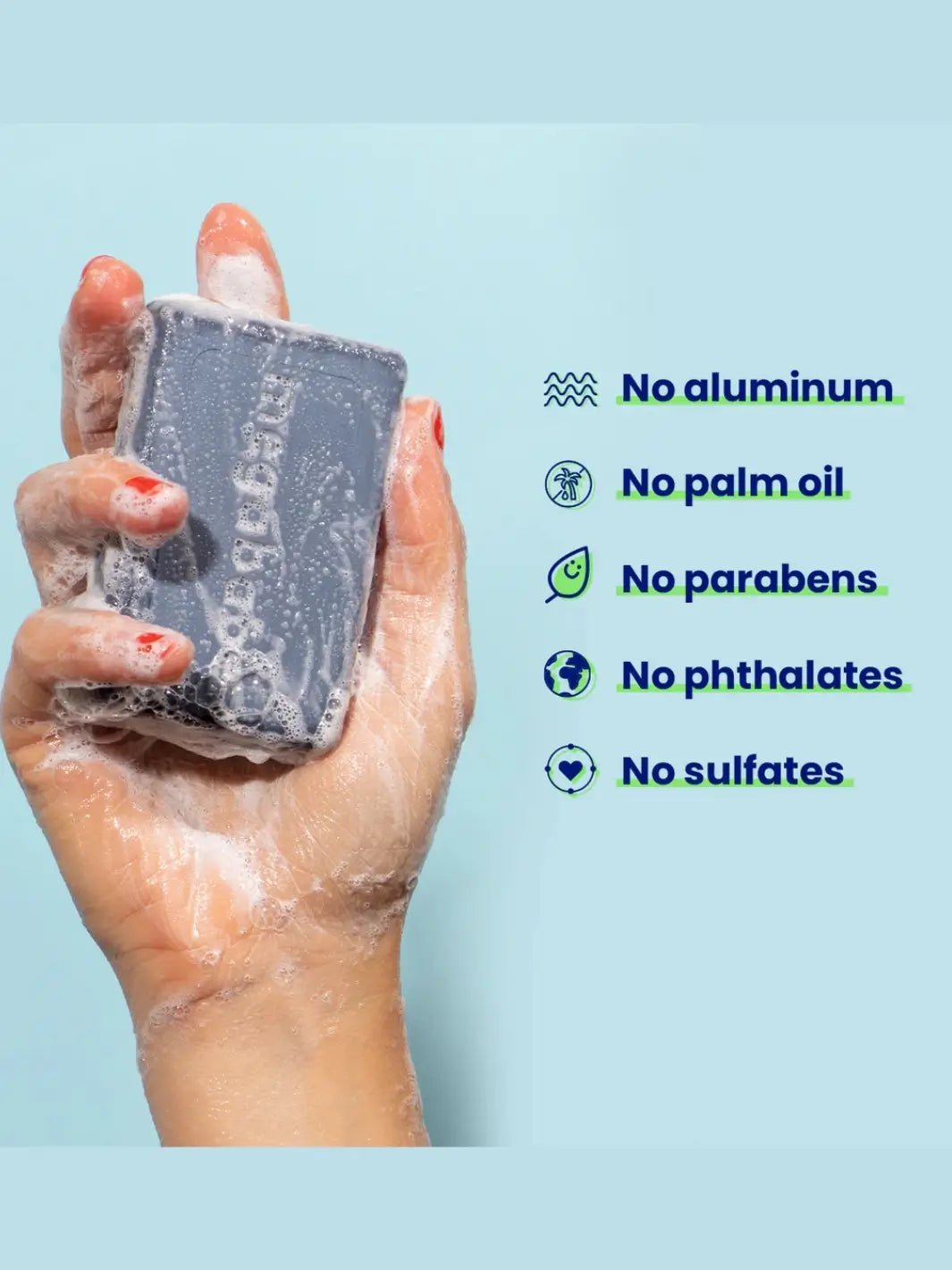 Hand holding a bar soap 'Space Bar' from Megababe with a list of ingredients on a light blue background | Twentyseven Toronto