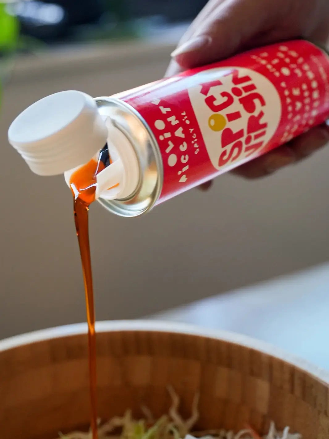 Red can of Spicy Virgin Olive Oil from Casa Virgin being poured into a bowl | Twentyseven Toronto