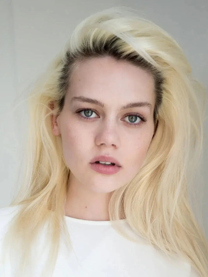 A model with a bright blonde hairstyle showcases clean volume and lifted roots styled with R+Co SPIRITUALIZED Wet Dry Shampoo | Twentyseven Toronto