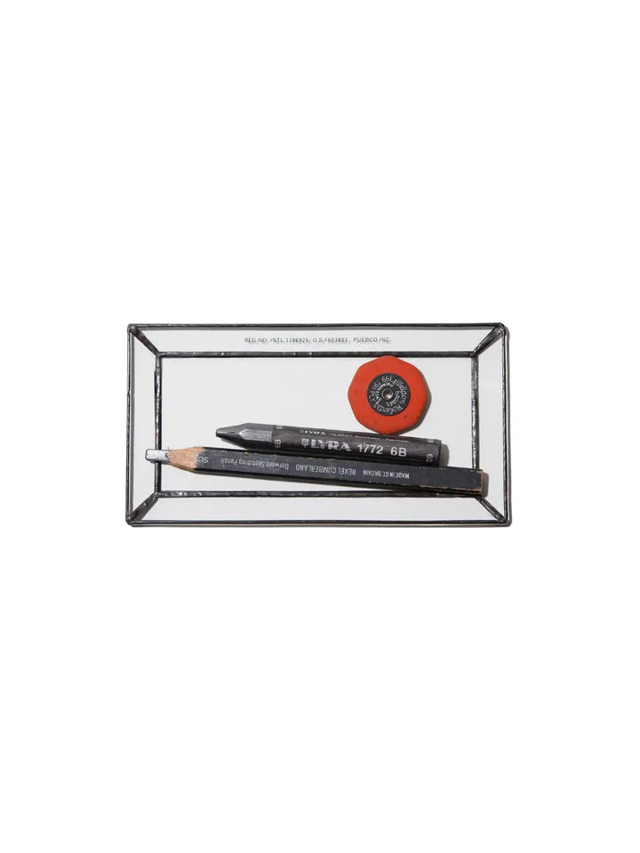 Rectangular Stained Glass Tray from Puebco, holding two sketching pencils and a round orange eraser against a white background | Twentyseven Toronto