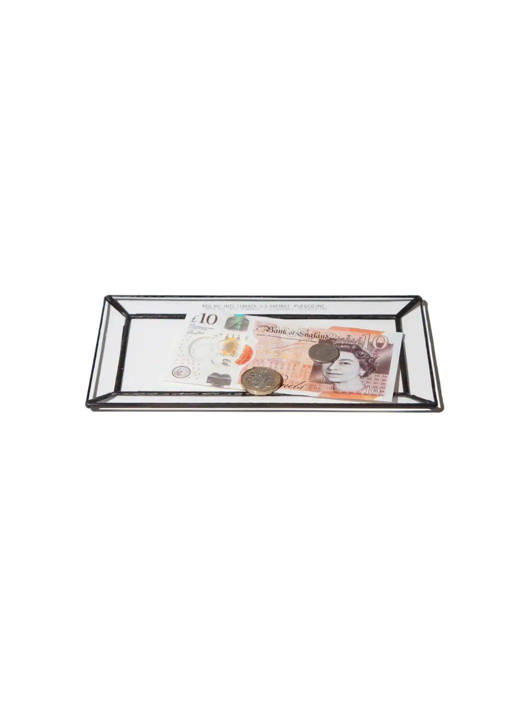 An angled shot of a rectangular Stained Glass Tray from Puebco containing a British ten-pound note and two coins | Twentyseven Toronto