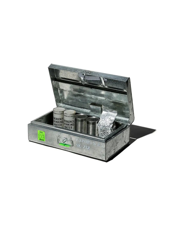 An open Steel Trunk / 11L from Puebco used as a tactical storage container filled with emergency drinking water cans and rations | Twentyseven Toronto