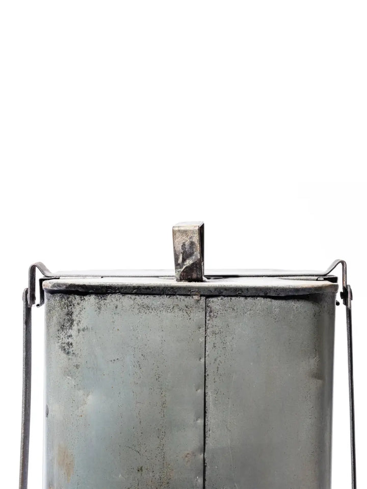Detailed shot focuses on the industrial rear hinge mechanism, central top handle, and rustic seamed construction of the Step Trash Can - Natural from Puebco | Twentyseven Toronto